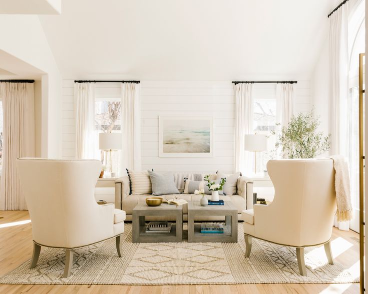 a living room filled with furniture and white walls