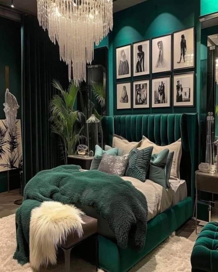 a green bedroom with pictures on the wall and chandelier hanging from the ceiling