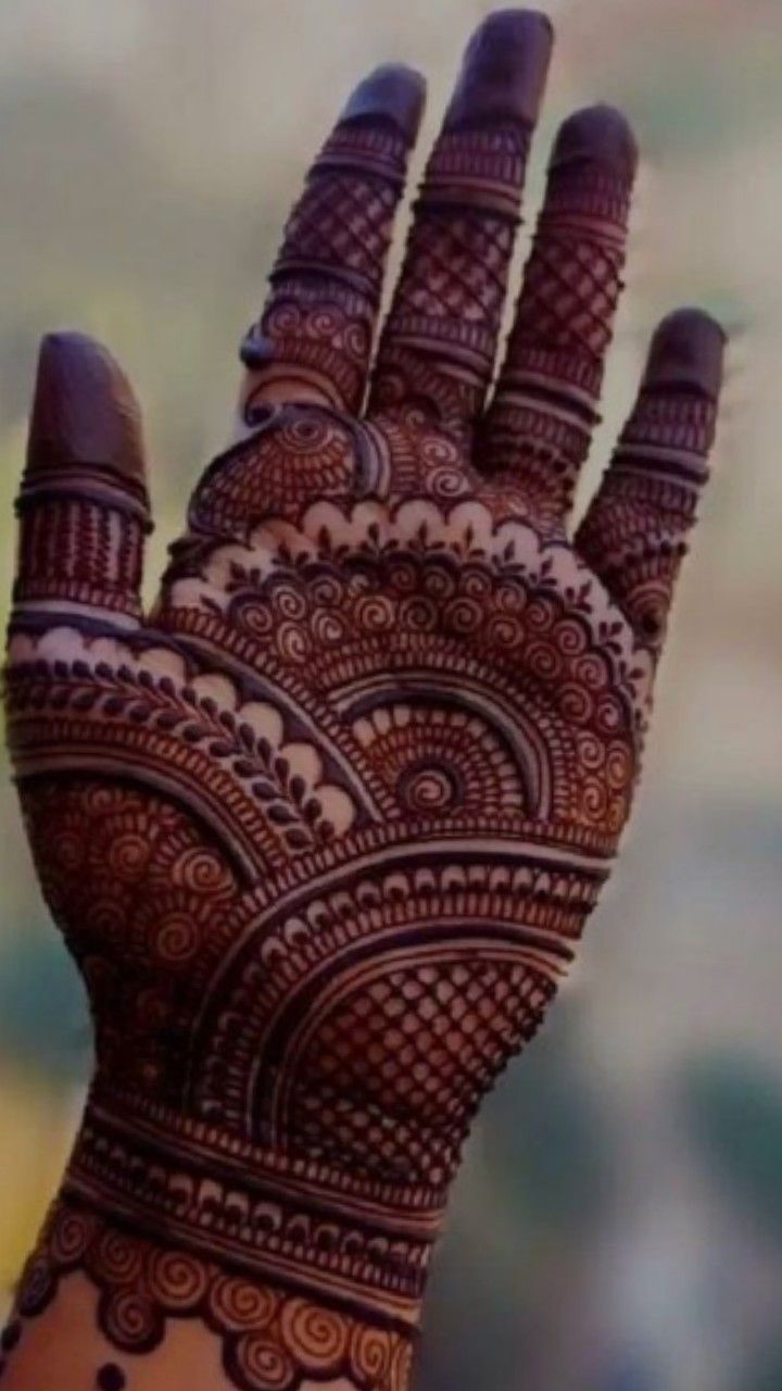 the hand is decorated with intricate designs