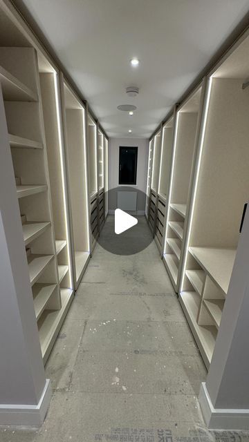 an empty walk in closet with shelves and lights