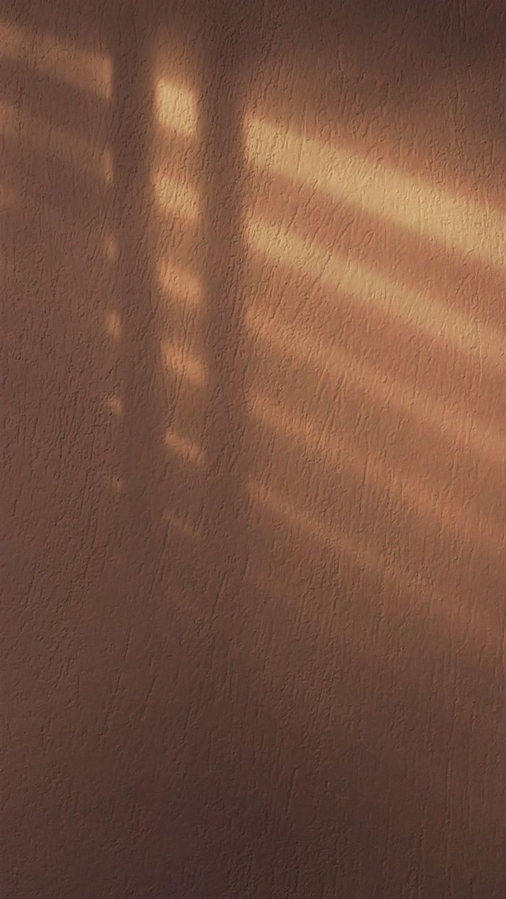 the shadow of a clock on a wall