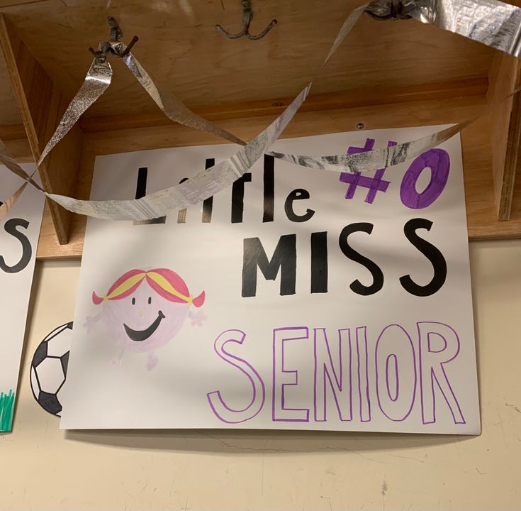 a sign that says little miss and is hanging from the ceiling with ribbons around it