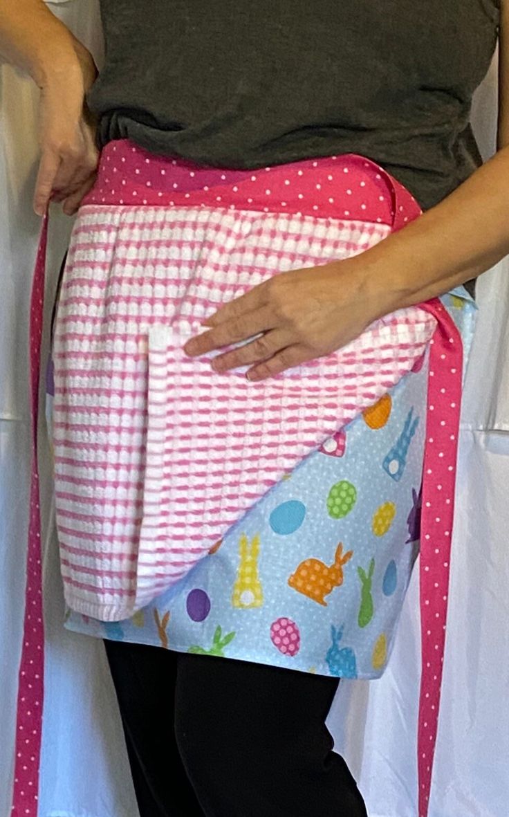 a woman is holding an apron in her hands