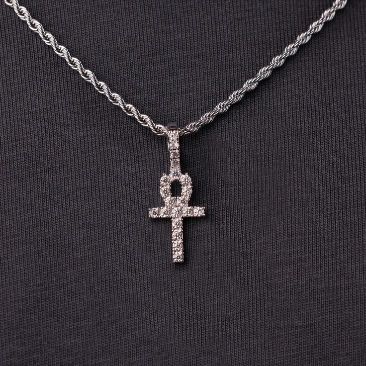 Known as “The Key of the Nile” the Ankh is one of the most sacred Egyptian symbols representing eternal life. We carefully hand-set all stones, executing top craftsmanship. This micro-sized pendant now in white gold is sleek and will accentuate any fit. This product is guaranteed for life - GLD will repair the item should you experience any defects in craftsmanship or breakage. Specifications - 11mm x 19mm (Width x Height) - Bail: Fits up to 4mm Rope Chain - Weight: (Weight can vary +/- 0.5 gram White Gold Cross Jewelry For Spiritual Style, Spiritual White Gold Pendant Jewelry, Spiritual White Gold Cross Jewelry, Iced Out White Gold Cross Pendant Jewelry, White Diamond Spiritual Jewelry, Spiritual White Diamond Jewelry, Symbolic White Gold Cross Pendant Jewelry, Symbolic Diamond Jewelry With Gemstones, Symbolic Diamond Pendant Jewelry