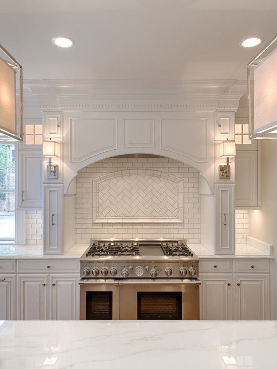 a white kitchen with an oven and range