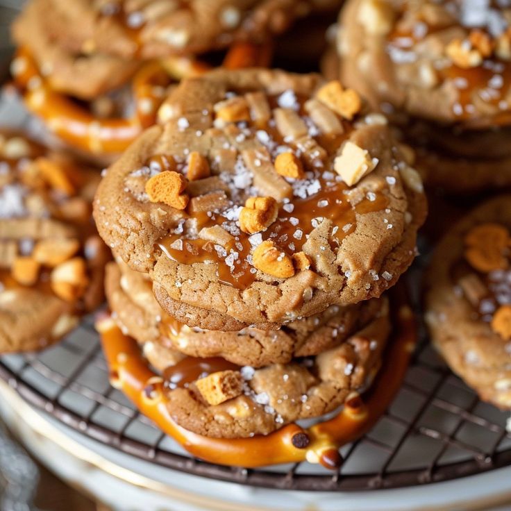 several cookies are stacked on top of each other with caramel drizzles