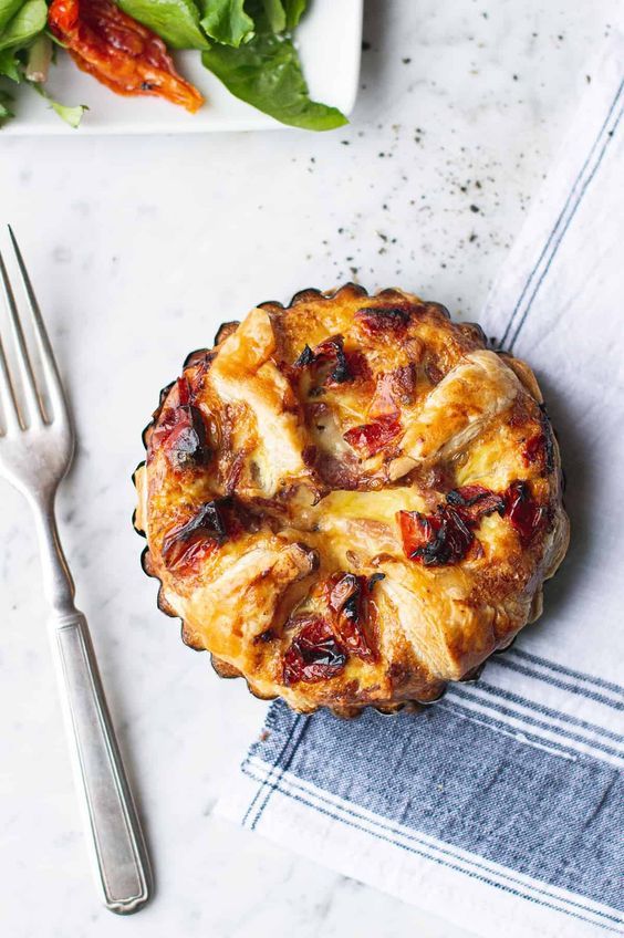 a pie sitting on top of a table next to a fork