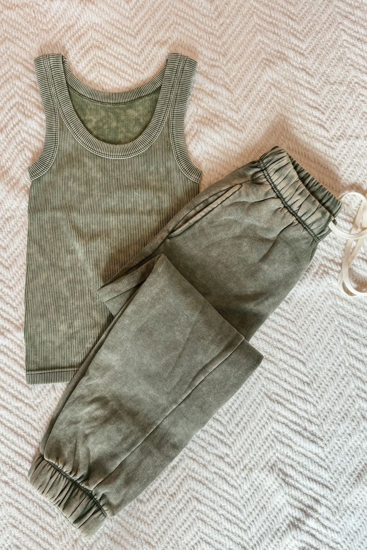 Unwind in style with our Weekend Hangs Lounge Set! These acid washed fleece jogger sweatpants provide ultimate coziness, while the stretchy waist ensures a comfortable fit. Paired with a super stretchy ribbed tank that offers a flattering look, you'll never want to take this set off. Relax and lounge in luxury! Fit: Tanks are fitted, pants are relaxed. Tank : 90% nylon, 10% spandex Pants : 60% cotton, 40% polyester Fitted Pants, Spandex Pants, Layered Sweater, Fleece Joggers, Ribbed Tank, Lounge Set, Jogger Sweatpants, Lounge Sets, Denim Pants