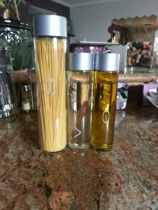 three glass cups sitting on top of a counter next to each other with pasta in them