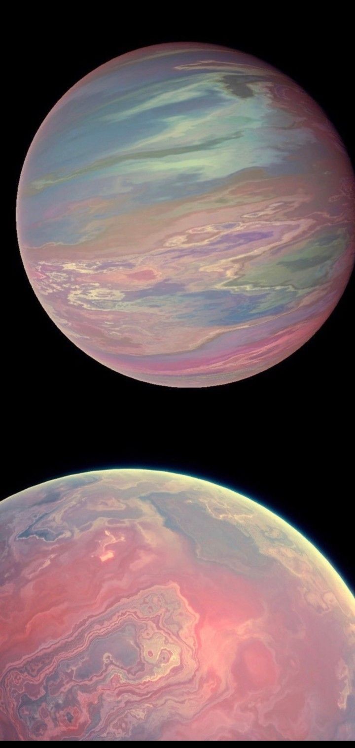 two large planets are shown in this composite image, one is pink and the other is blue