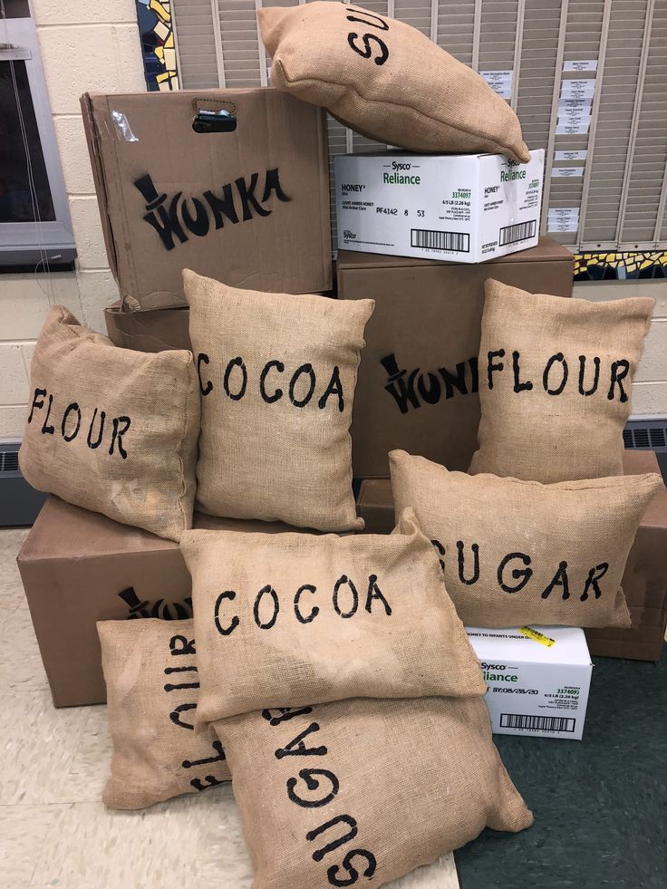 many bags are stacked on top of each other in front of boxes with words written on them