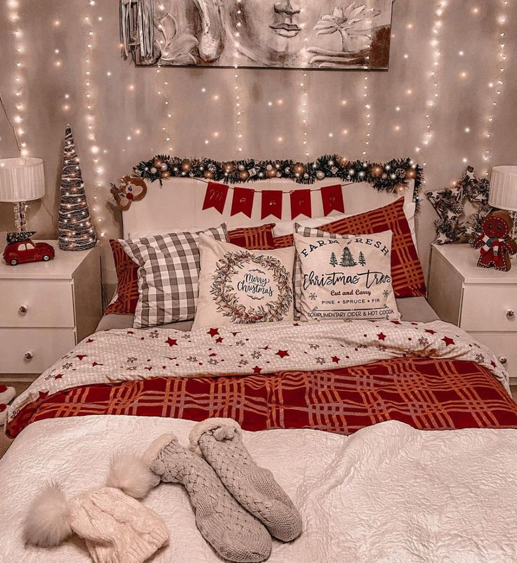 a bedroom decorated for christmas with lights on the wall and bed in the foreground