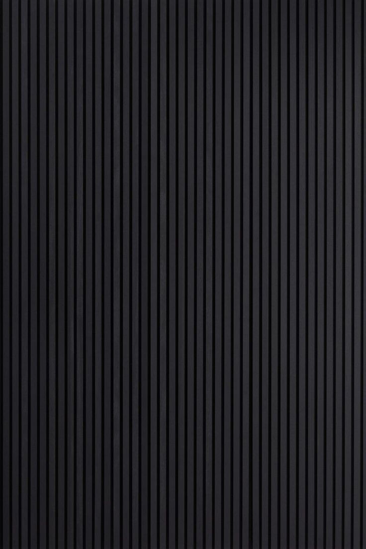 a black wall with vertical lines painted on it