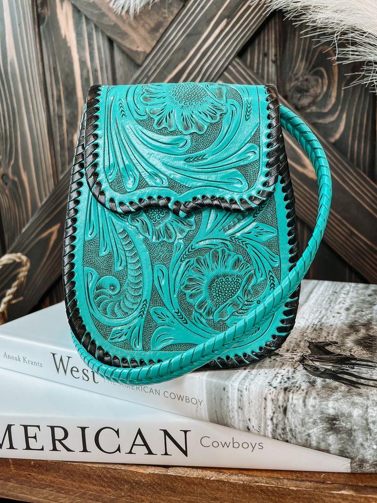 A perfect go-to everyday purse and easy to use as a going out purse. Small enough to be simple to carry but big enough to hold all you need. Comes with braided adjustable crossbody strap. Fully lined with an inner side pocket. Measures: 6.5"W x 8"H x 3"D 100% Leather Turquoise Crossbody Bag With Adjustable Strap, Turquoise Crossbody Bag With Detachable Strap, Turquoise Crossbody Shoulder Bag With Detachable Strap, Turquoise Crossbody Shoulder Bag With Removable Pouch, Turquoise Everyday Pouch Shoulder Bag, Turquoise Hand Tooled Everyday Bags, Turquoise Hand Tooled Bags For Everyday Use, Turquoise Hand Tooled Rectangular Shoulder Bag, Hand Tooled Turquoise Bag For Everyday Use