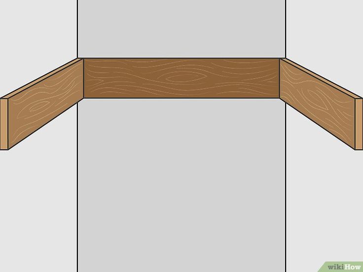 the corner of a wooden shelf with woodgrains on top and bottom, as well as