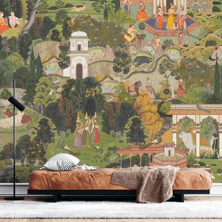 a large mural on the side of a wall next to a bed with pillows and blankets