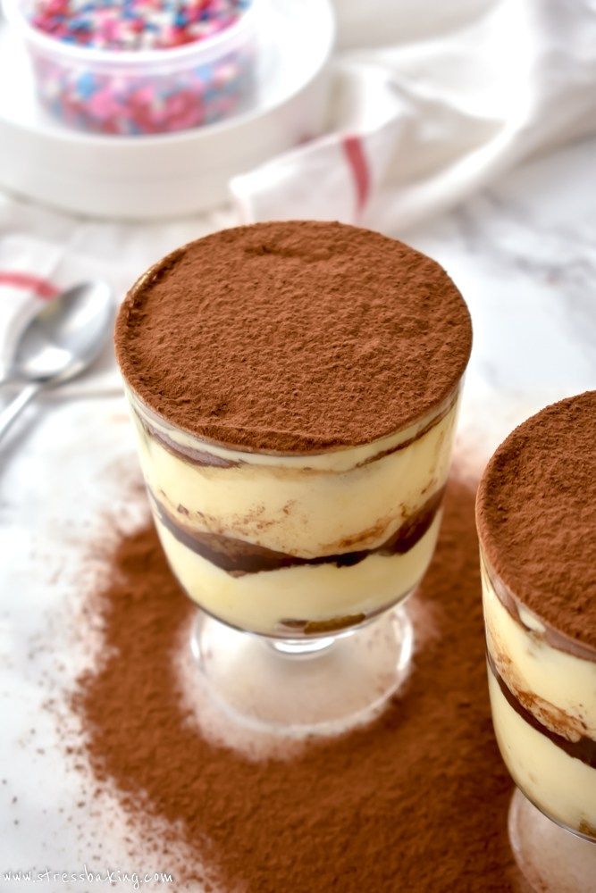 two desserts sitting on top of a table covered in chocolate