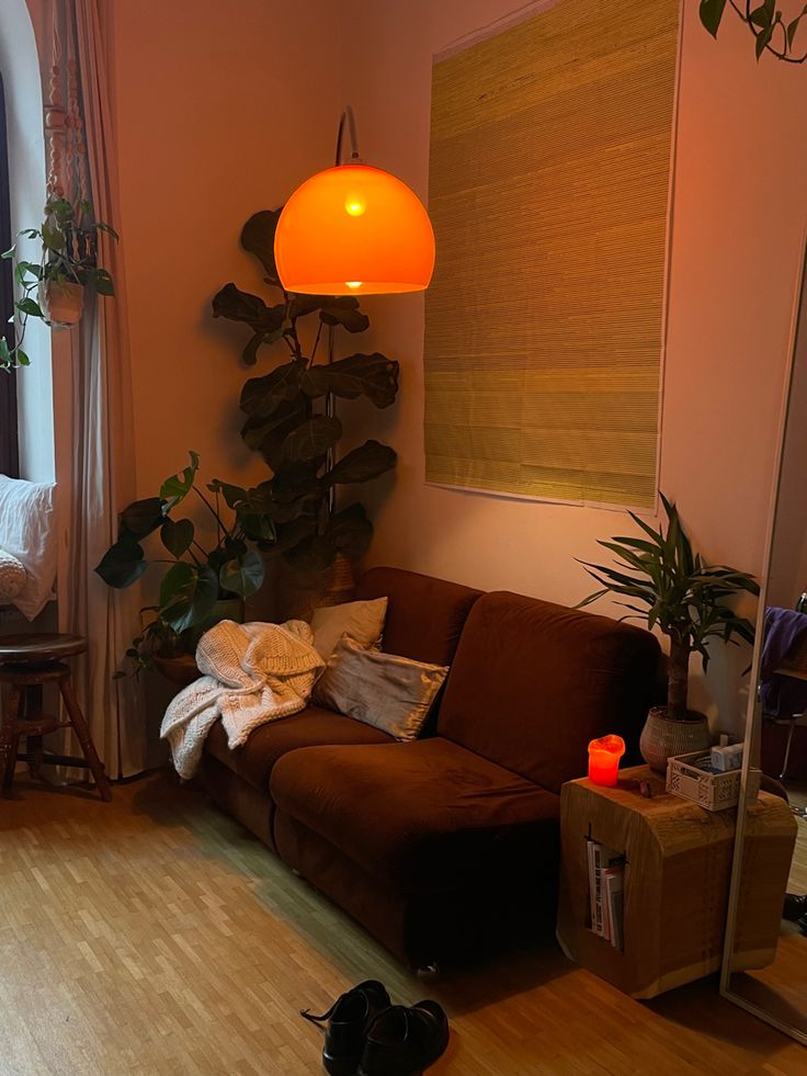 a living room filled with furniture and a large lamp hanging over it's head