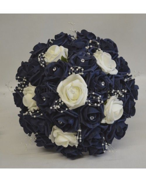 a bridal bouquet with white roses and pearls