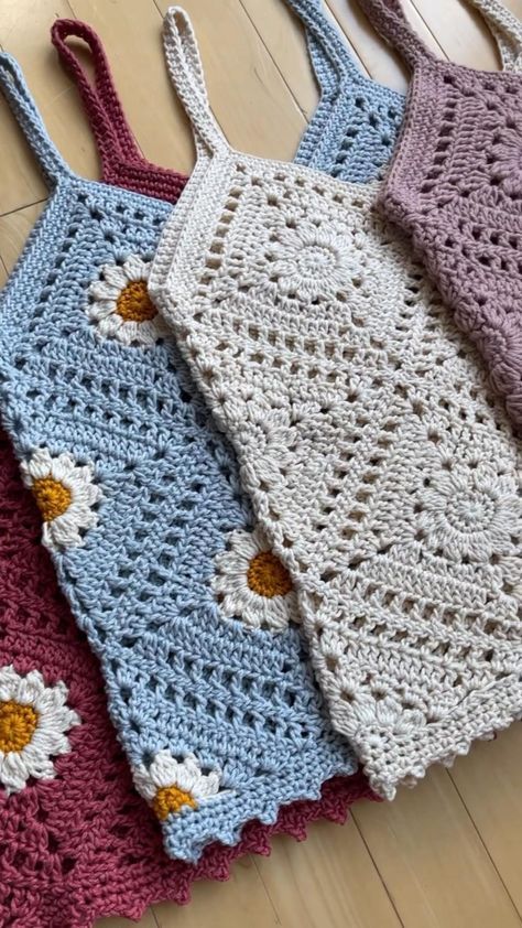 four crocheted bags sitting on top of a wooden floor next to each other