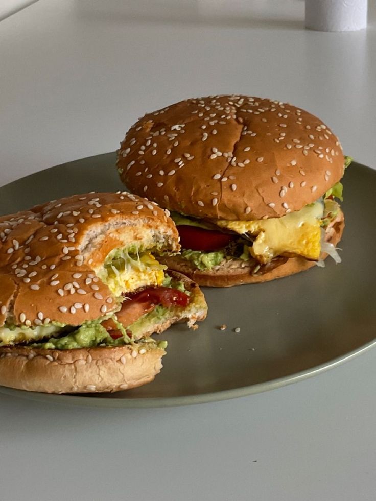 two burgers sitting on top of a metal plate