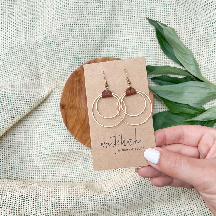 We had so much fun creating the original pair, so we decided to make a smaller version of one of our best selling designs! Having a cute pair of earrings, like these rich brown leather & brass circles earrings is a necessity! ••••••••••••••••••••••••••••••••••••••••••••••••••••••••••••••• ORDERING •These leather earrings measure approx 1 3/8" wide, 2 1/8" drop with hook.These earrings feature raw brass accents. Please note raw brass will naturally oxidize over time, creating a beautiful vintage Everyday Gold-colored Copper Jewelry, Brown Small Hoop Earrings With Ear Wire, Brown Metal Hoop Earrings, Everyday Brass Circular Earrings, Everyday Brass Circle Earrings, Everyday Circular Brass Earrings, Nickel-free Brown Jewelry For Gifts, Minimalist Brown Hoop Earrings For Everyday, Modern Brown Round Jewelry