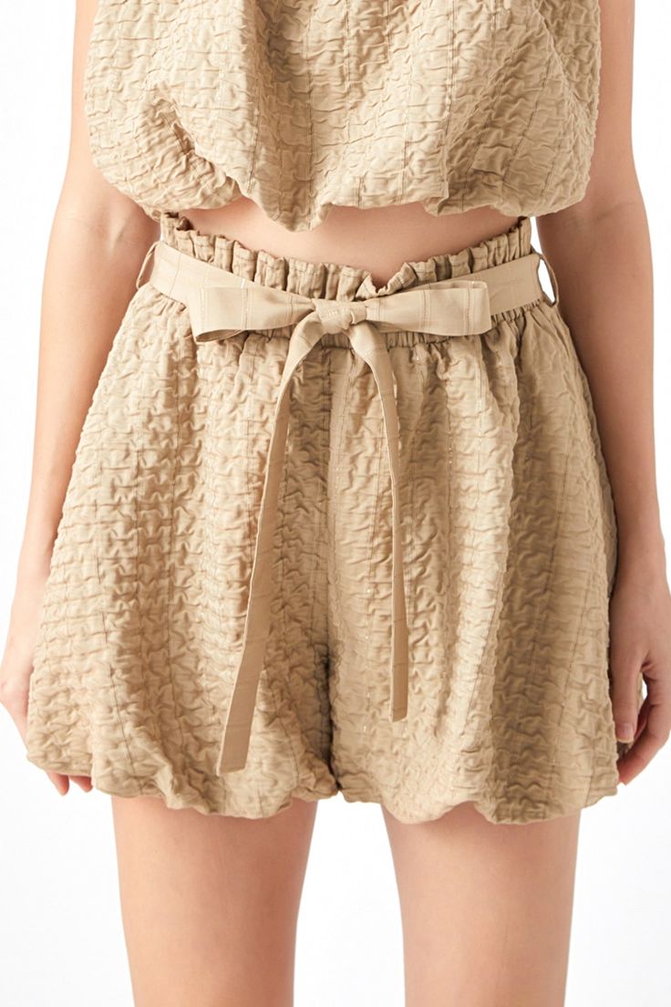 Looking for a cute and professional way to show off your legs? Look no further than our Bubble Elastic Shorts! Made from light brown fabric, these shorts are perfect for any occasion. Pair with the matching crop top or style with a white crop top to complete the look. Textured woven fabric Elastic waist Self fabric waist belt Shell: 50% Polyester 40% Rayon 10% Other Lining: 100% Polyester JJ861P Total length: 15" Waist: 27" Inseam: 3" XS TAN: Height 5'9" / Bust 30.5" / Waist 24" / Hips 34.5" Beige Bottoms With Built-in Shorts For Day Out, Trendy Khaki Shorts For Summer, Brown Cotton Shorts For Day Out, High Waist Khaki Shorts For Summer, Summer Khaki Shorts With Short Inseam, Khaki Shorts With Short Inseam For Summer, Chic Beige Cropped Bottoms, Summer High-waisted Khaki Shorts, Khaki High-waisted Summer Shorts