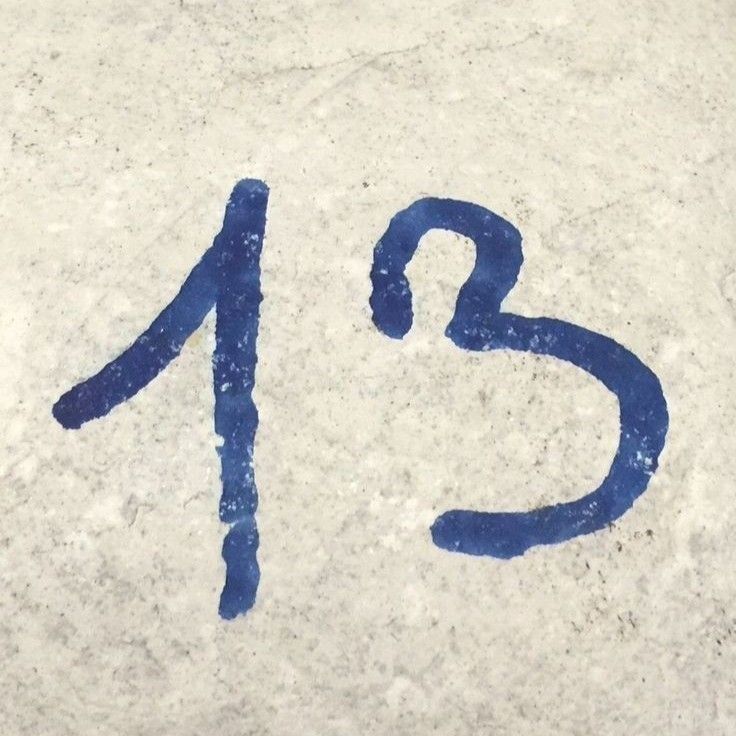 the number twenty thirteen painted on concrete with blue paint