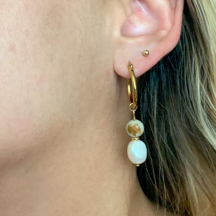 Just like Earth herself, Gisele earrings are fresh and natural. *Due to the organic shape of nature, the freshwater pearls can differ in size shown on image.* Care Store jewelry in microfiber Club Paradiso pouch. To clean, use microfiber pouch to wipe away dirt and oil buildup. Avoid contact with chemicals (lotions, perfumes, etc) to prevent fading. Material Gold plated brass with freshwater pearls and organic stone. RETURNS Although we do not accept returns. We will make an exception on case by Gold Natural Stones Drop Pearl Earrings, Gold Pearl Earrings With Natural Stones, Elegant Gold Hoop Earrings With Natural Stones, Gold Dangle Pearl Earrings With Natural Stones, Gold Earrings With Natural Stones For Everyday, Everyday Gold Earrings With Natural Stones, Jewelry Promo, Store Jewelry, Asymmetrical Design