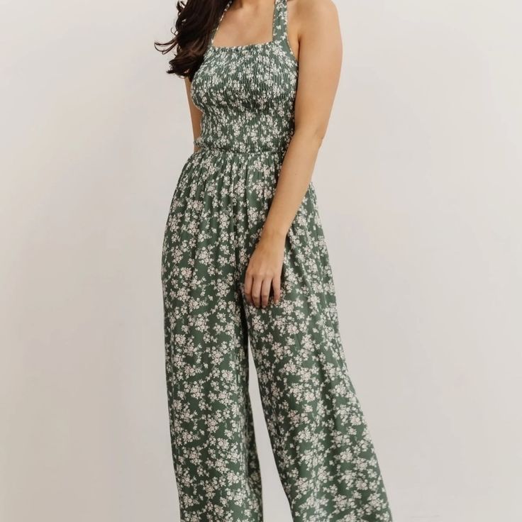 Our New Lana Halter Jumpsuit Is Effortlessly Beautiful! It Features A Smocked Bodice, Wide Pant Legs, And A Green Ditsy Floral Print. Sleeveless Cotton Jumpsuit With Smocked Bodice, Cotton Sleeveless Jumpsuits And Rompers With Smocked Bodice, Sleeveless Floral Print Jumpsuits, Sleeveless Non-stretch Floral Jumpsuits And Rompers, Spring Brunch Jumpsuits And Rompers With Smocked Bodice, Spring Cotton Jumpsuit With Smocked Bodice, Summer Fitted Jumpsuits And Rompers With Smocked Bodice, Spring Jumpsuits And Rompers With Smocked Bodice For Brunch, Spring Cotton Jumpsuits And Rompers With Smocked Bodice