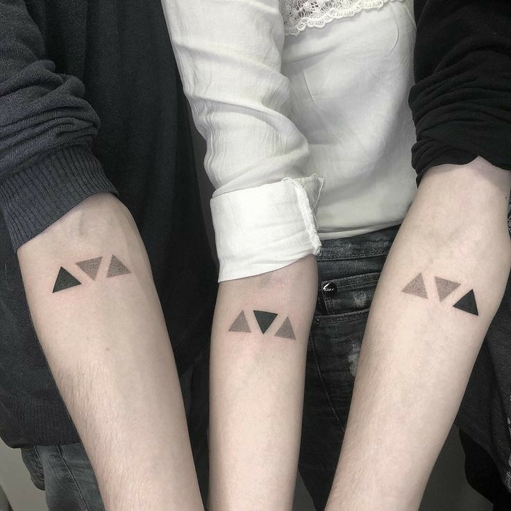 two people with matching tattoos on their arms