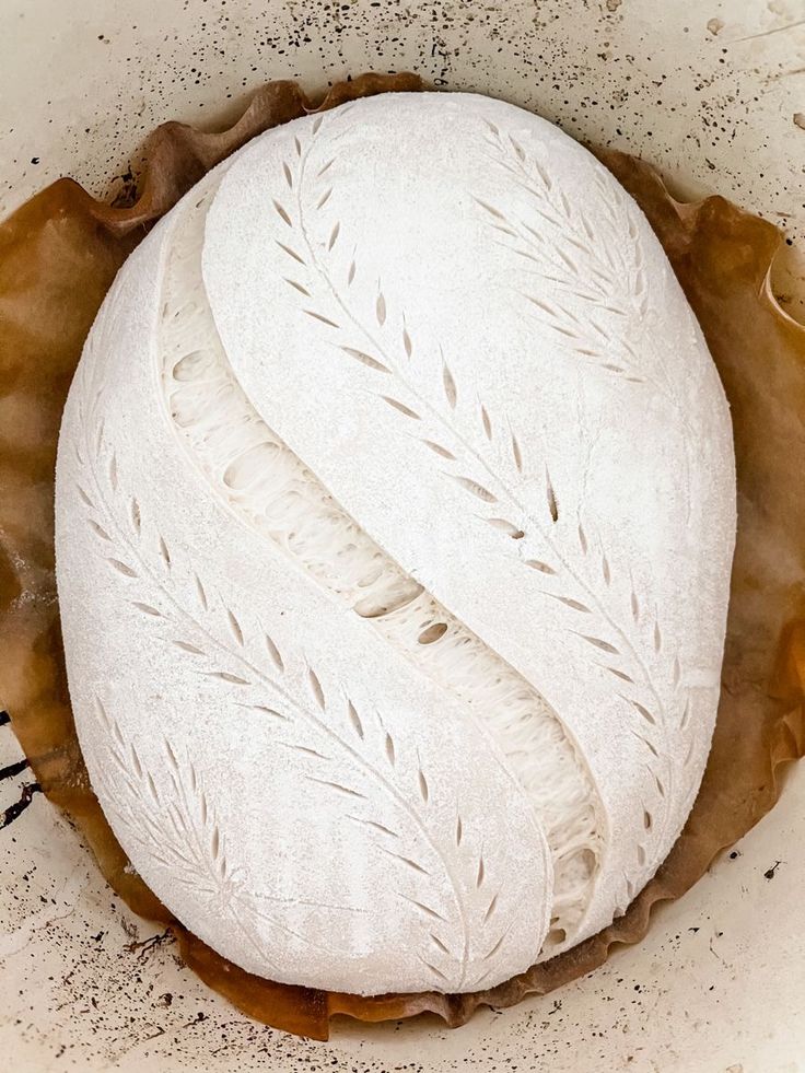 a white bread in a bowl with brown sprinkles