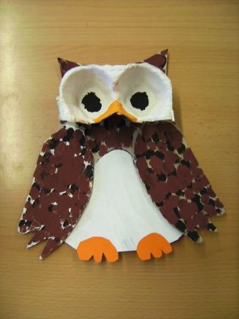 an owl made out of paper sitting on top of a table