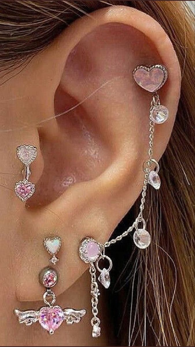 a woman wearing ear piercings with charms