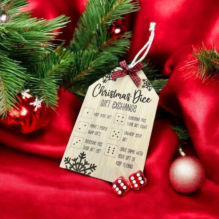 a christmas tree ornament hanging from the side of a red cloth with ornaments around it