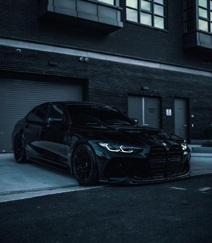 a black car parked in front of a building