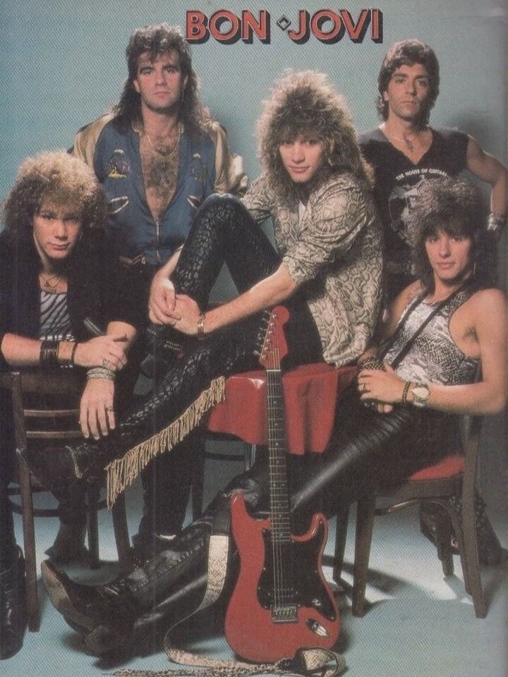 the band bon - jovi is posing for a photo with their guitars and guitar