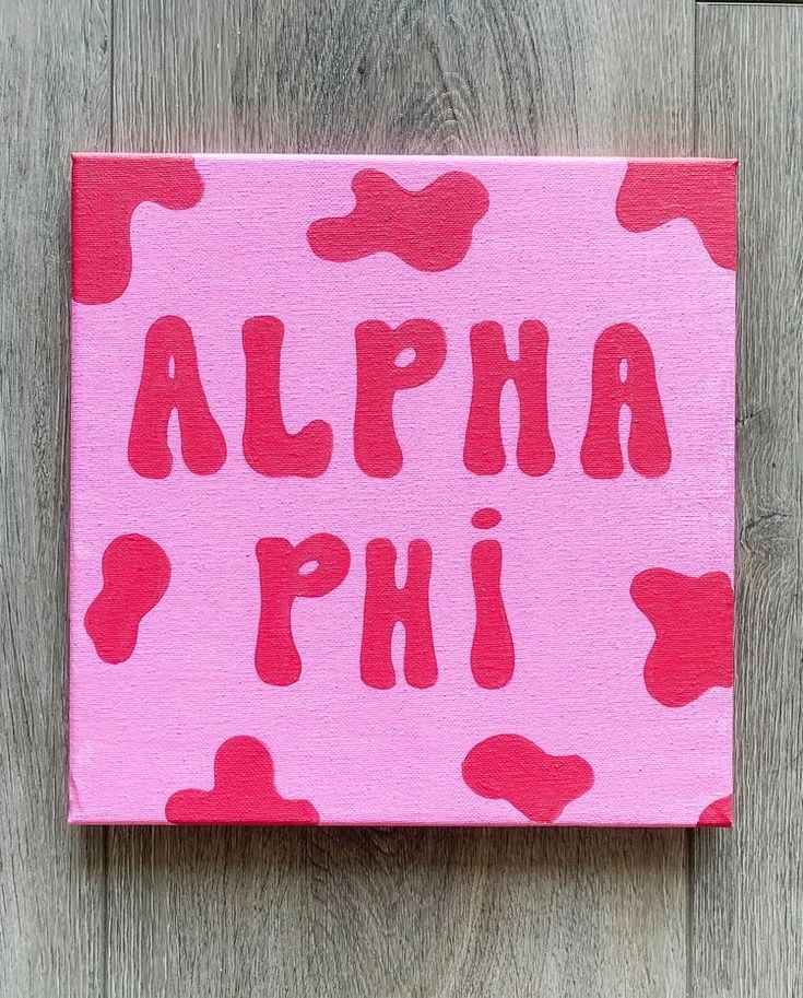 a pink and red painting with the words alpha phi on it