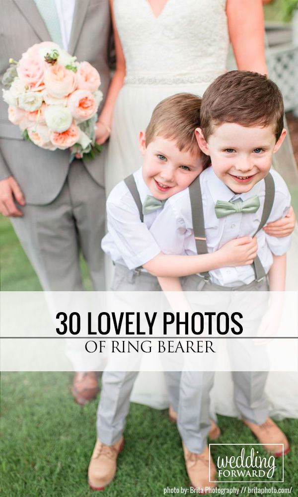 two young boys are hugging each other in front of the bride and groom