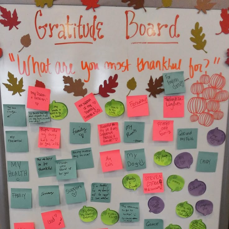 a bulletin board with notes and leaves on it