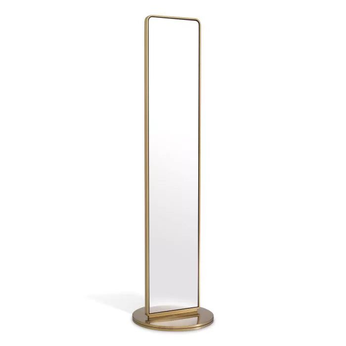 a tall mirror on a stand with a white back ground and gold trim around the edges