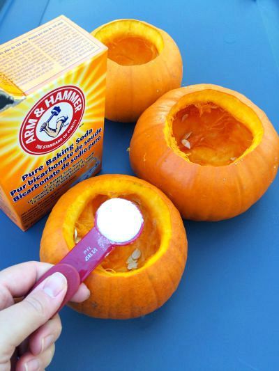 someone is peeling the inside of two pumpkins