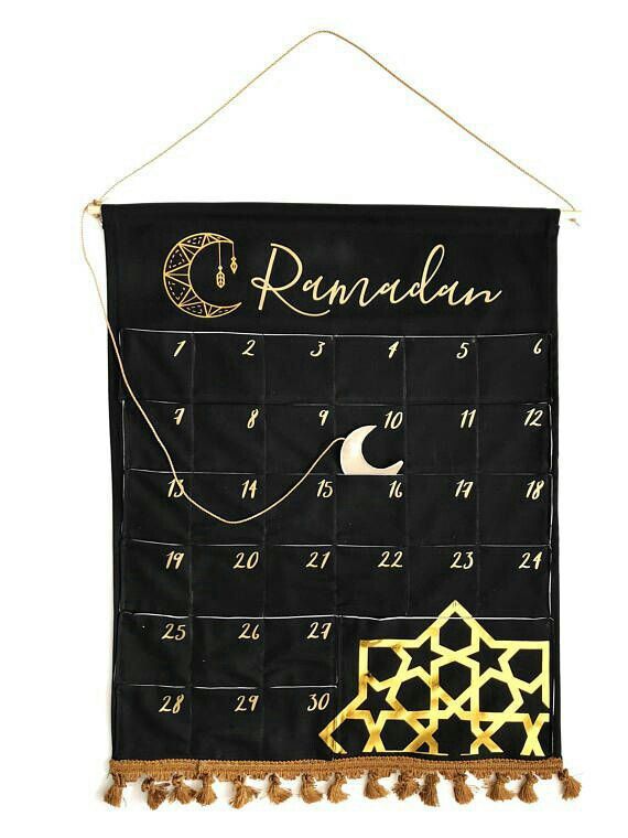 a black and gold calendar hanging on a wall