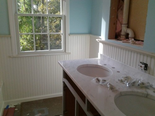 a bathroom with two sinks and a window