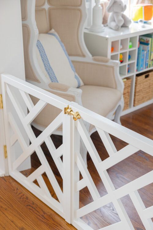 a baby's room with a chair, bookcase and toys in the background