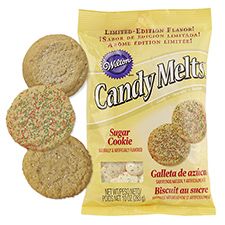 three cookies with sprinkles and candy melts in front of the package