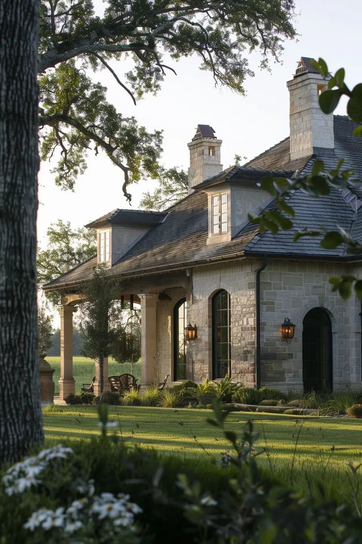 a large stone house in the middle of a field