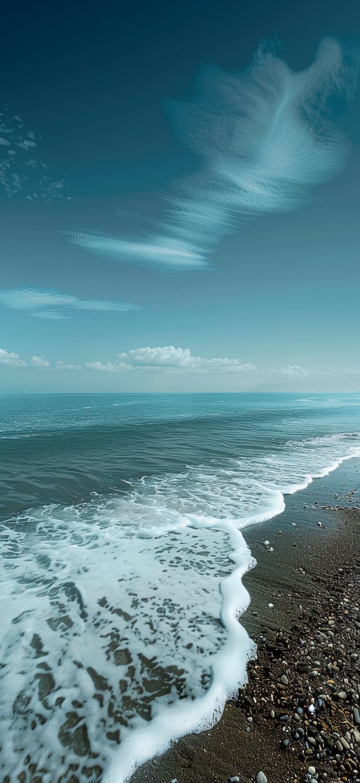 an ocean beach with waves crashing on the shore and clouds in the sky above it