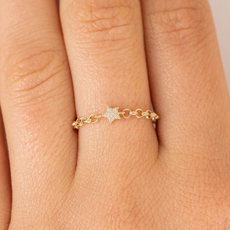 Vega You and this ring were written in the stars! This 14k gold ring is one of a kind, featuring a dainty diamond star charm and a gold chain. If you love this ring, you’ll definitely want to check out our other chain rings! - Handmade- Solid Gold- Natural Diamonds - G Color, SI Quality Diamonds- Total Diamond Carat Weight: 0.02 ctw All pieces come beautifully boxed in suede pouches you can always use when traveling! Dainty Star-shaped Diamond Jewelry, 14k Gold Star Ring With Single Diamond, Celestial 14k Gold Star Diamond Ring, Gold Star-shaped Everyday Rings, 14k Gold Star-shaped Diamond Ring, Sterling Silver Wedding Band, Star Chain, Diamond Star, Star Ring