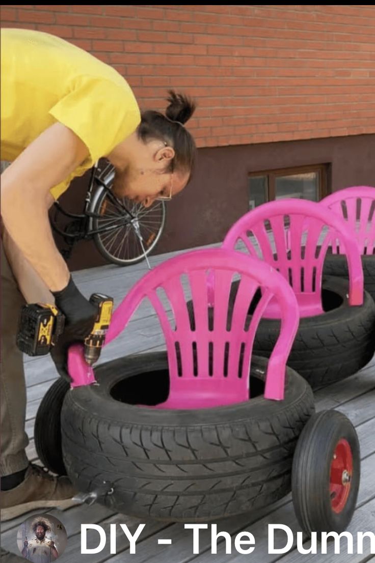 a woman working on some pink chairs made out of old tire rims and tires